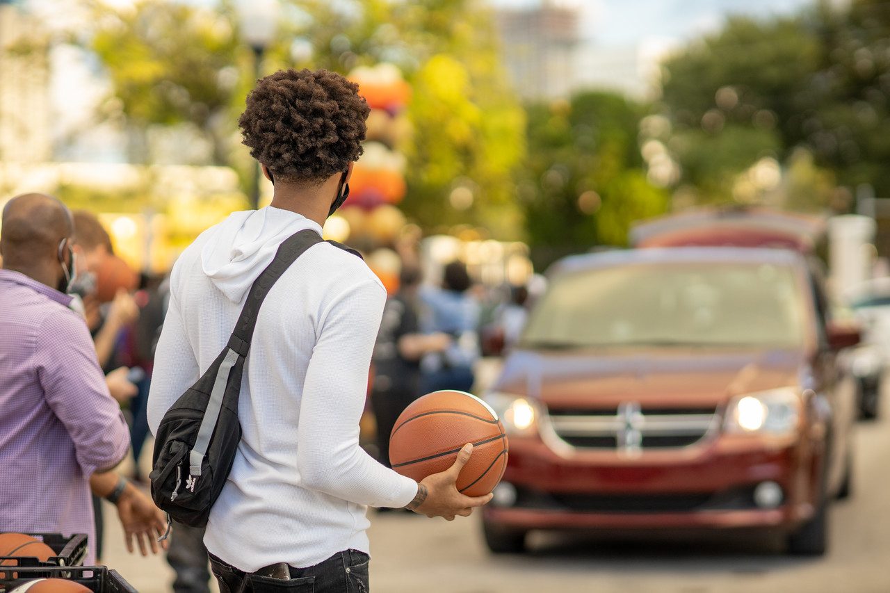 A parent and teenager in the car after a basketball game